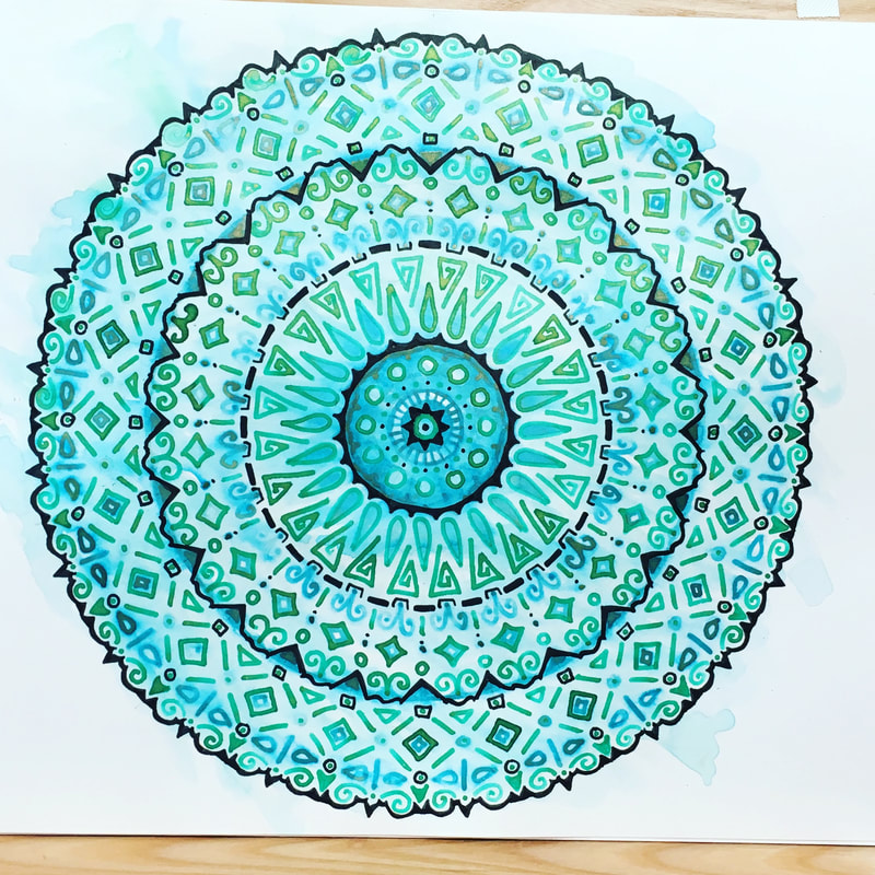 hand drawn pen and ink mandala with geometric patterns