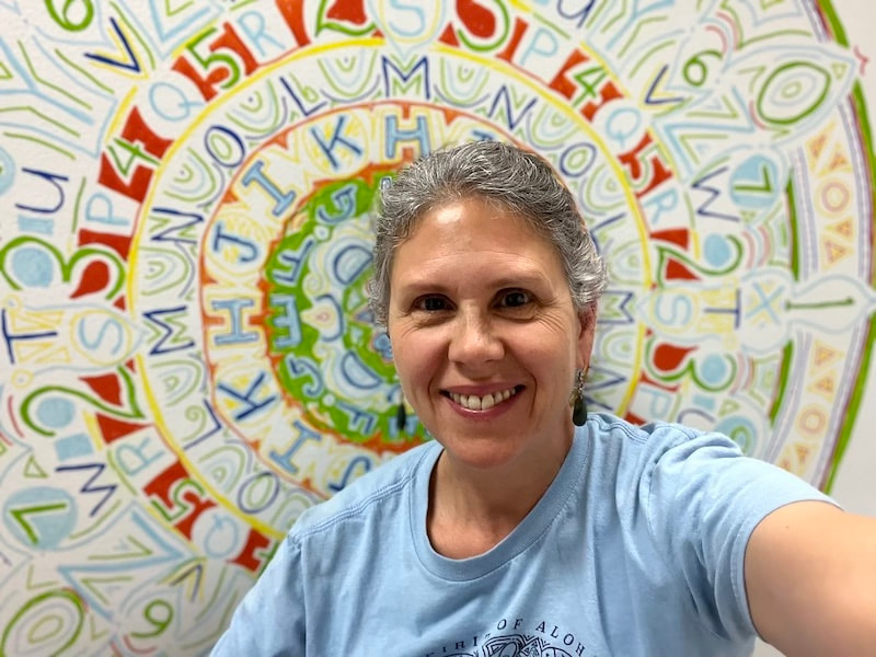 April Castoldi by letter and number mandala mural at Los Ninos Services, Valhalla, New York