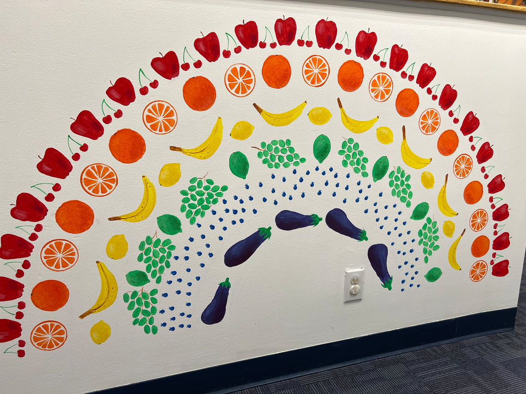 Hand-painted fruit and vegetable rainbow mural